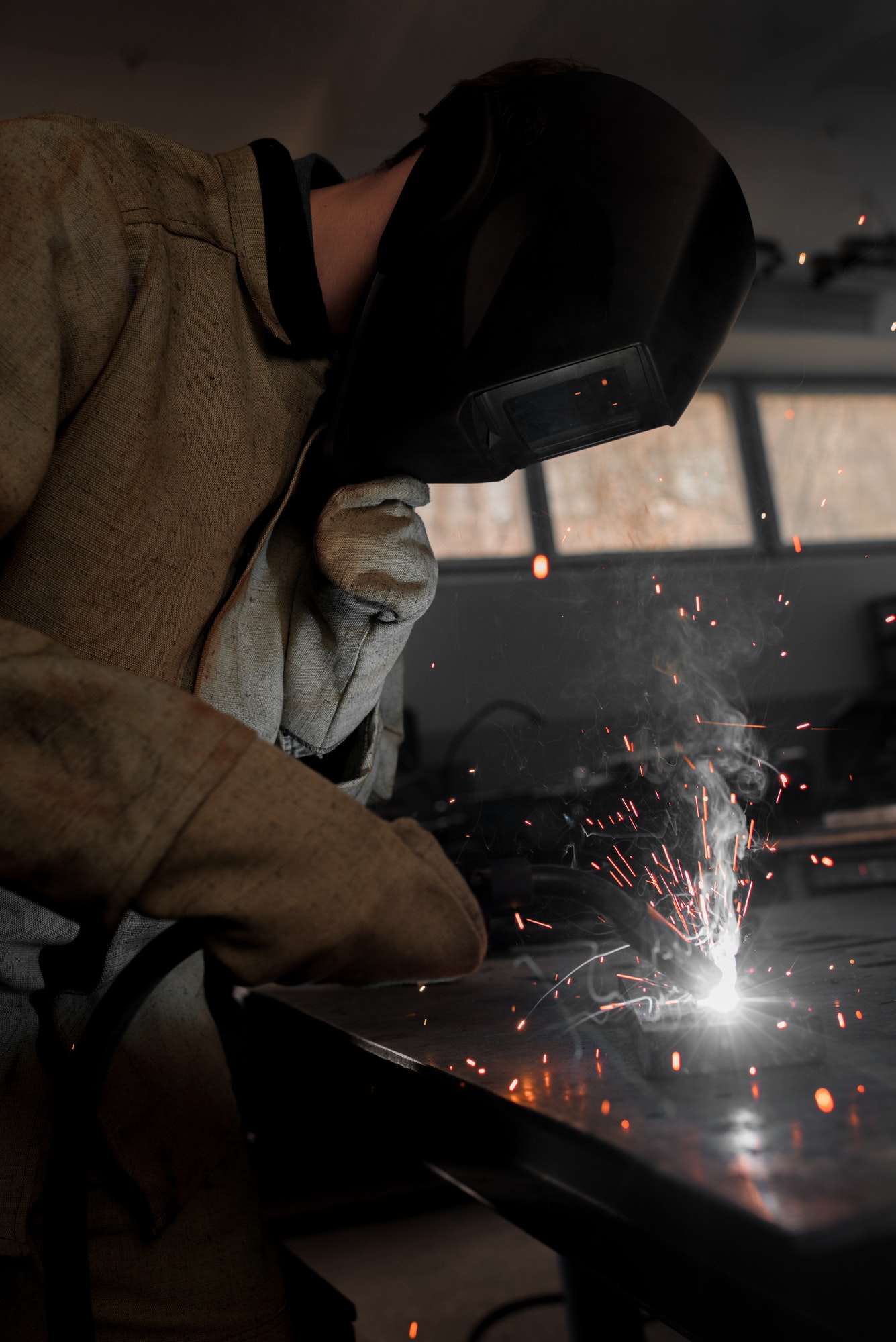 worker-in-protection-mask-welding-metal-at-factory.jpg